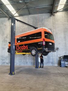 Ascenta 5500CF – 2 Post Hoist lifting a van
